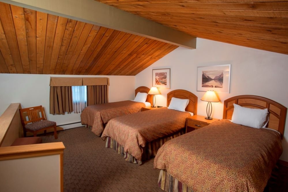 The jasper inn & suites loft bedroom with 3 single beds