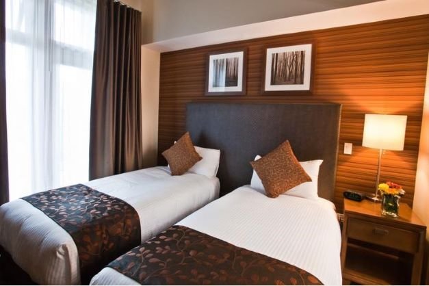 Revelstoke the sutton place hotel bedroom with 2 twin beds.jpg